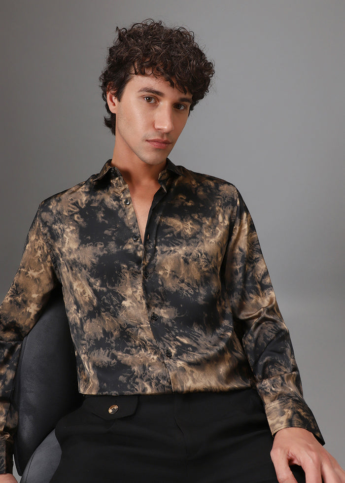 Man wearing a camouflage shirt sitting on a chair against a gray background