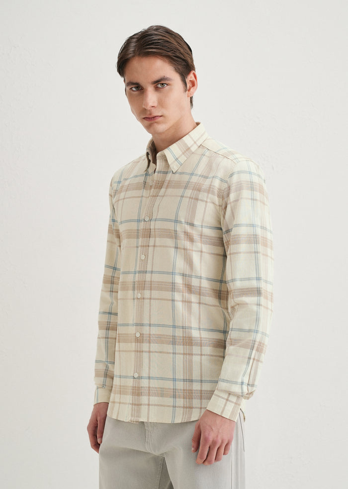 Man wearing a plaid shirt on a white background