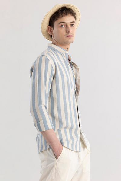 Man wearing a striped shirt and hat against a plain background