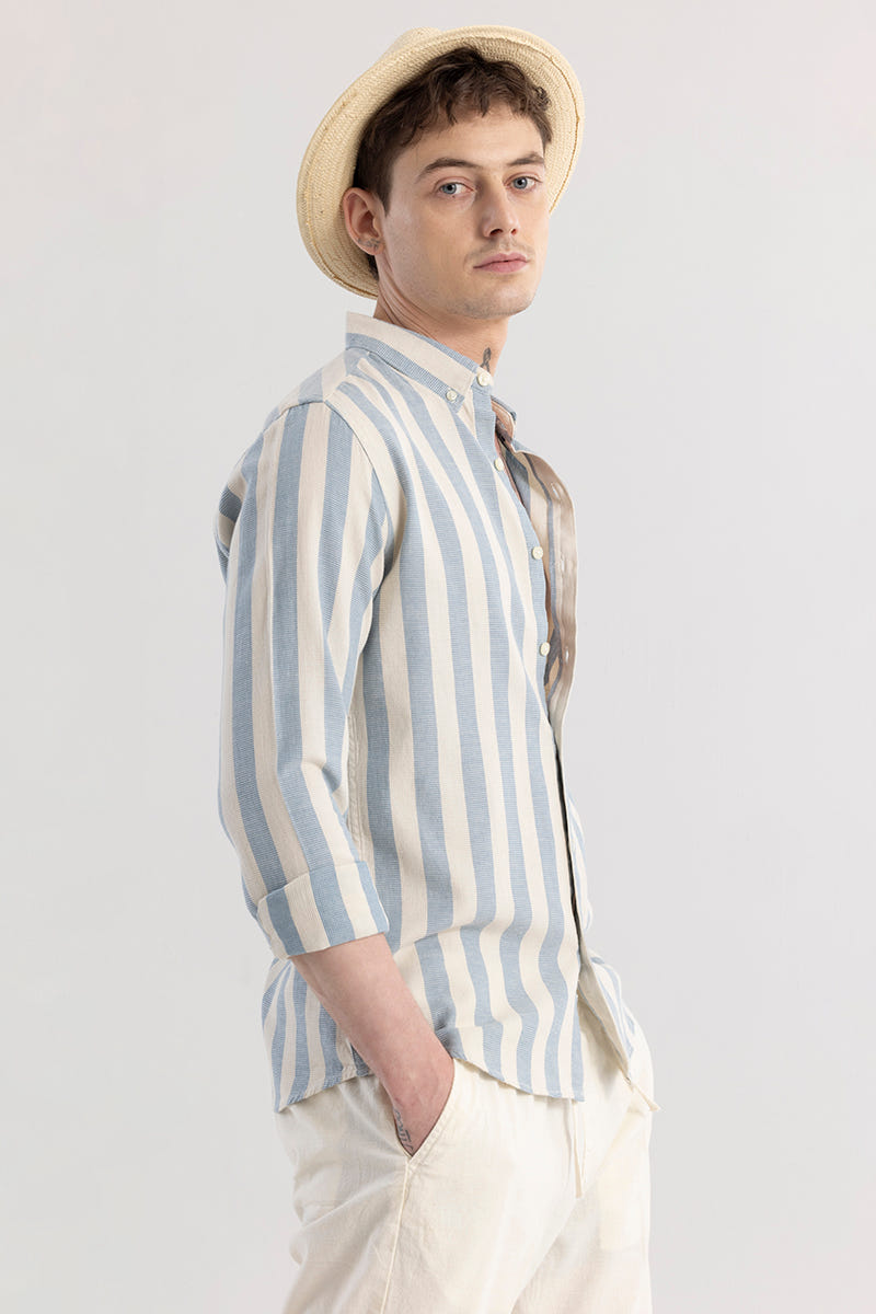 Man wearing a striped shirt and hat against a plain background