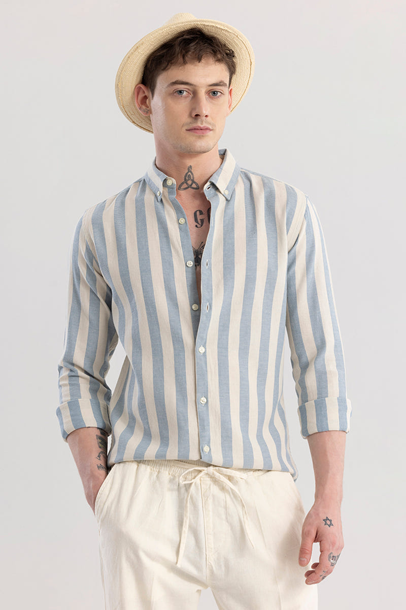 Man wearing a striped shirt and straw hat against a plain background