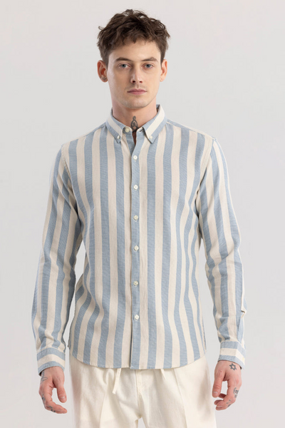 Man wearing a blue and white striped shirt against a plain background